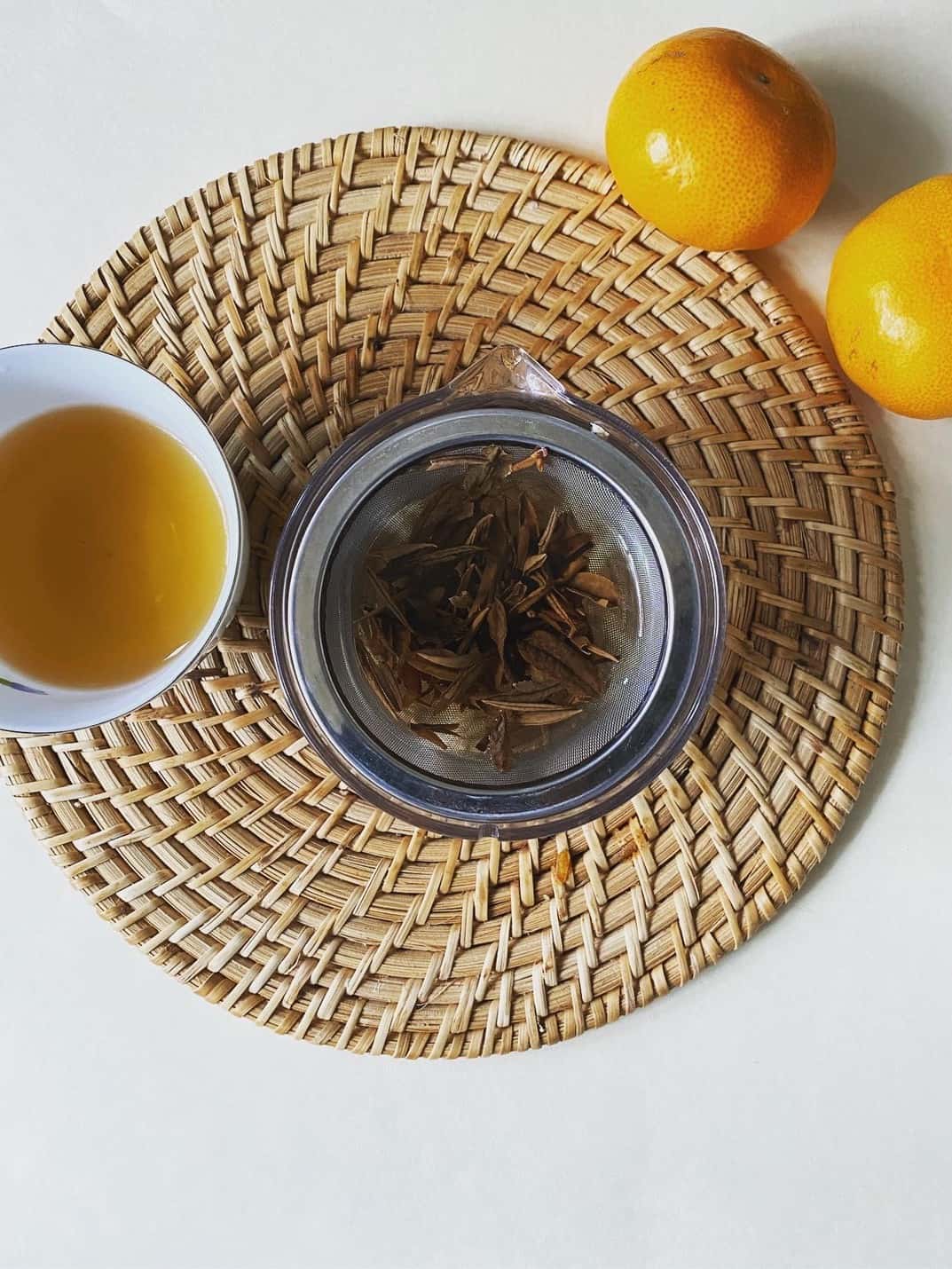 Tea leaves steeping with fresh oranges